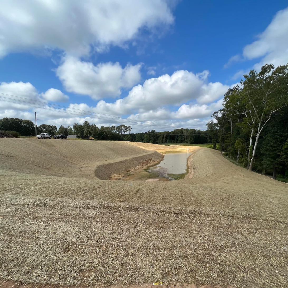 Newly graded stormwater detention pond with erosion blanket in Georgia
